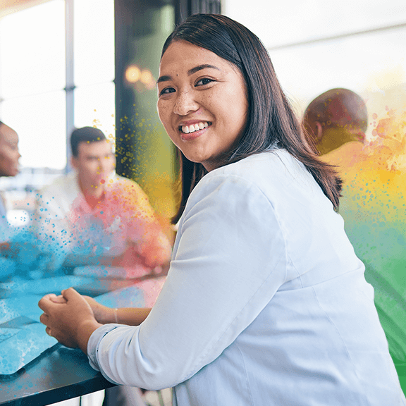 Woman in an office, smiling with crossed arms