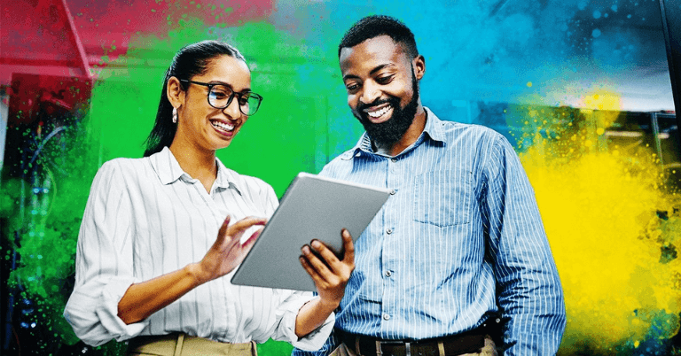 Two coworkers using AI technology on a tablet