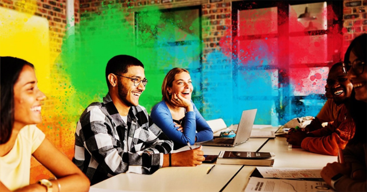 Happy team around a conference table, using DiSC for better meetings