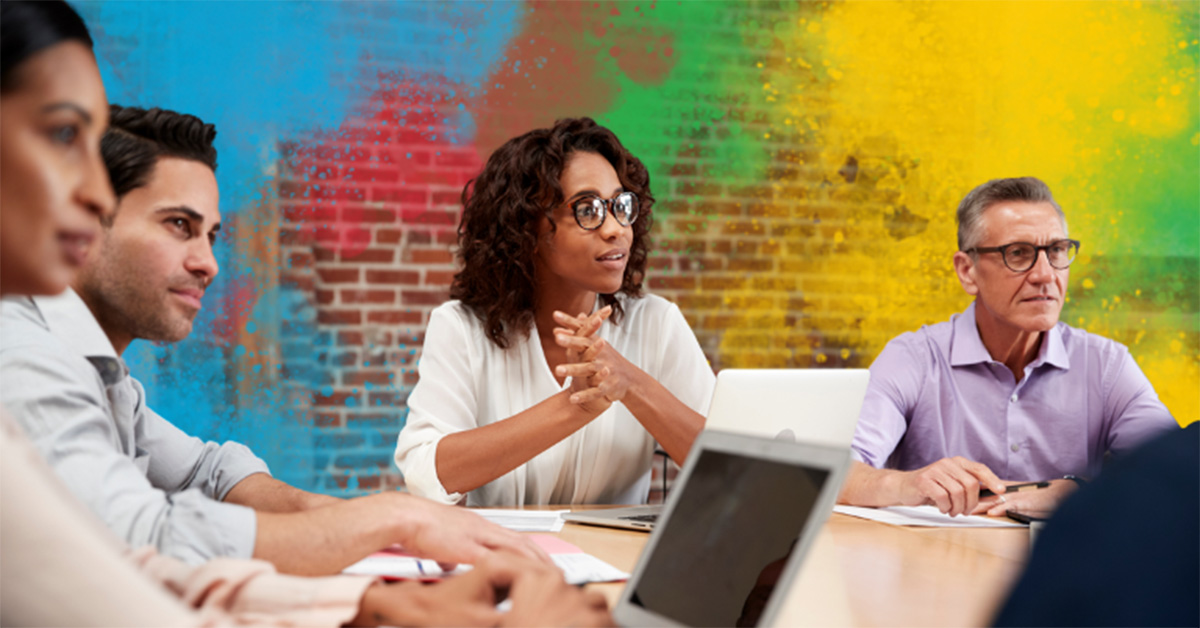 Image of a leader asking questions at a team meeting