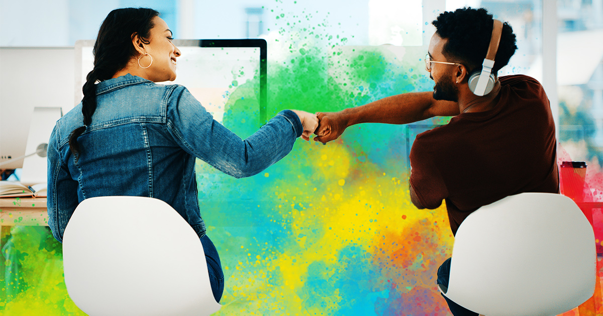 Two coworkers celebrating with each other and building a positive workplace culture