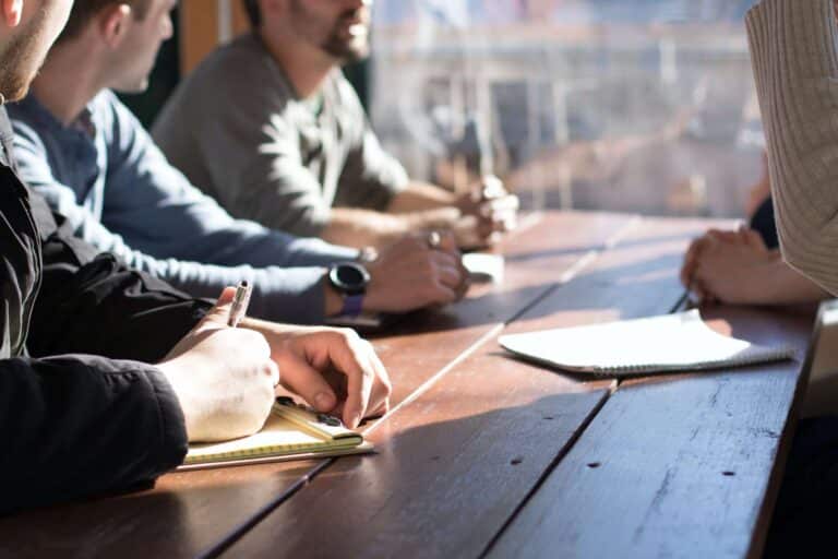 people paying attention to team member during meeting